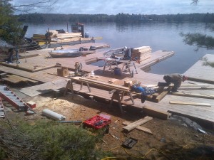 First day of boathouse construction on Lake Muskoka.  Barge provides easy access to building materials for the workers